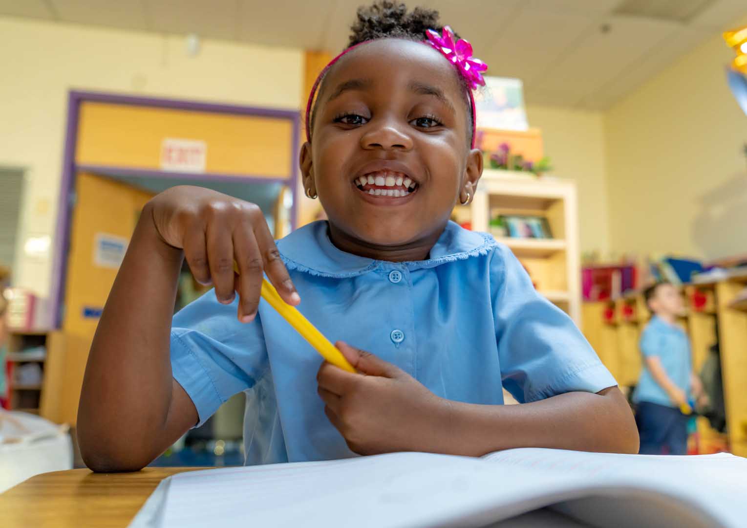  student smiling with pencil